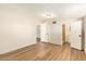 Neutral bedroom with a doorway and an attached bathroom featuring wood-look flooring at 122 N 5Th St, Avondale, AZ 85323