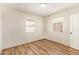 Bright bedroom with wood-look flooring and natural light from two windows at 122 N 5Th St, Avondale, AZ 85323