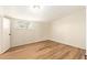 Neutral bedroom with a single window offering natural light, featuring wood-look flooring at 122 N 5Th St, Avondale, AZ 85323