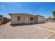 Single-story home with a gravel front yard and a sidewalk leading to the front door at 122 N 5Th St, Avondale, AZ 85323