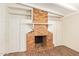Close up on a red brick fireplace with built-in shelves and white paneling at 122 N 5Th St, Avondale, AZ 85323
