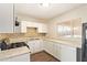 Well-lit kitchen with white cabinets, stylish backsplash, and modern appliances, ready for cooking at 122 N 5Th St, Avondale, AZ 85323