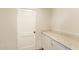Functional laundry area with granite countertop, cabinetry, and a door at 122 N 5Th St, Avondale, AZ 85323