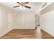 Open living room with wood-look floors, a ceiling fan, and neutral tones, creating a welcoming space at 122 N 5Th St, Avondale, AZ 85323
