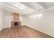 Bright living room with a charming brick fireplace and wood-look floors at 122 N 5Th St, Avondale, AZ 85323