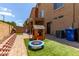 Cozy backyard featuring brick pavers, artificial turf, and a charming playhouse for entertainment at 1350 S Greenfield Rd # 1123, Mesa, AZ 85206