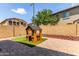 Backyard featuring a playhouse and a brick wall for privacy at 1350 S Greenfield Rd # 1123, Mesa, AZ 85206