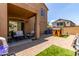 A spacious backyard featuring a covered patio with outdoor seating, a playhouse, and manicured turf at 1350 S Greenfield Rd # 1123, Mesa, AZ 85206