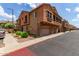 Charming townhome showcasing unique architecture with a stone-accented facade and private garages at 1350 S Greenfield Rd # 1123, Mesa, AZ 85206