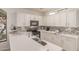 Modern kitchen boasting white cabinetry, stainless steel appliances, and elegant countertops at 1350 S Greenfield Rd # 1123, Mesa, AZ 85206
