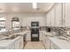 Well-lit kitchen features white cabinetry, marbled countertops, and stainless steel appliances at 1350 S Greenfield Rd # 1123, Mesa, AZ 85206