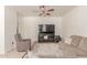 Spacious living room with cozy seating arrangement, ceiling fan, and a media center at 1350 S Greenfield Rd # 1123, Mesa, AZ 85206