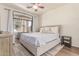 Cozy bedroom showcases neutral tones, plush rug, and sliding glass doors to a balcony at 1350 S Greenfield Rd # 1123, Mesa, AZ 85206