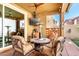 Well-appointed covered patio featuring comfortable seating, an outdoor television, and a ceiling fan at 1528 N Balboa --, Mesa, AZ 85205