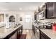 Modern kitchen with stainless steel appliances, dark cabinets, granite counters, and wood floors at 1528 N Balboa --, Mesa, AZ 85205