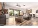 Bright living room featuring stylish decor, wood flooring, and sliding glass doors to the backyard at 1528 N Balboa --, Mesa, AZ 85205