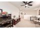 Spacious loft area with plush carpet, ceiling fan, media center, piano, and open floorplan at 1528 N Balboa --, Mesa, AZ 85205