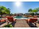 Community pool area with ample seating, a sun-drenched deck, and well-maintained landscaping providing resort-style living at 1528 N Balboa --, Mesa, AZ 85205