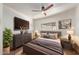 Relaxing bedroom with neutral tones, a ceiling fan, a dresser and modern décor, creating a tranquil retreat at 1545 E Christy Dr, Phoenix, AZ 85020