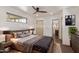 Comfortable bedroom featuring plush bedding, a ceiling fan, and access to an ensuite bathroom for added convenience at 1545 E Christy Dr, Phoenix, AZ 85020