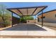 Modern carport with a metal roof and concrete pad, providing covered parking and access to the home at 1545 E Christy Dr, Phoenix, AZ 85020