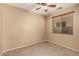 Bright bedroom showcasing a window with blinds and a ceiling fan, creating a comfortable and inviting space at 1612 W Lacewood Pl, Phoenix, AZ 85045