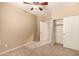 Neutral bedroom with a ceiling fan, carpet and closet at 1612 W Lacewood Pl, Phoenix, AZ 85045