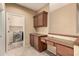 Desk area adjacent to laundry room including washer and dryer at 1612 W Lacewood Pl, Phoenix, AZ 85045