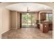 Dining area with tile floors, backyard views, and kitchen bar at 1612 W Lacewood Pl, Phoenix, AZ 85045