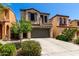 Charming two-story home with desert landscaping and a driveway leading to a two-car garage at 1612 W Lacewood Pl, Phoenix, AZ 85045