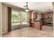 Kitchen and dining area featuring tile floors, backyard views, and ample cabinet space at 1612 W Lacewood Pl, Phoenix, AZ 85045