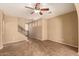 Spacious living room with tile flooring, ceiling fan, staircase and neutral wall colors at 1612 W Lacewood Pl, Phoenix, AZ 85045