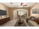 Inviting living room area with tile floors, opening to the dining room and kitchen bar at 1612 W Lacewood Pl, Phoenix, AZ 85045