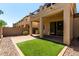 A cozy patio with brick pavers, artificial grass, and outdoor access creates a relaxing outdoor space at 1612 W Lacewood Pl, Phoenix, AZ 85045
