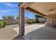 View of covered patio with desert landscaping and block wall at 16525 W Tranquility Ln, Surprise, AZ 85387