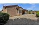 Backyard of home featuring desert landscaping and covered patio at 16525 W Tranquility Ln, Surprise, AZ 85387