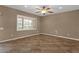 Bedroom featuring tile floors, a ceiling fan, and a large window with bright natural light at 16525 W Tranquility Ln, Surprise, AZ 85387