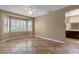 Large bedroom featuring tile floors, bay windows with shutters, and an attached bathroom at 16525 W Tranquility Ln, Surprise, AZ 85387