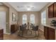 Charming dining room featuring two arched windows and tile flooring, complemented by modern furnishings and a ceiling fan at 16525 W Tranquility Ln, Surprise, AZ 85387