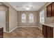 Empty dining room featuring natural light from the two arched windows, tile flooring, and neutral wall color at 16525 W Tranquility Ln, Surprise, AZ 85387