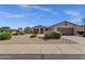 Charming single-story home with a well-maintained desert landscape, complemented by a spacious two-car garage at 16525 W Tranquility Ln, Surprise, AZ 85387