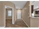 Inviting hallway featuring tile flooring, neutral walls, and an open view into the connecting rooms at 16525 W Tranquility Ln, Surprise, AZ 85387