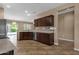 Bright kitchen with stainless steel dishwasher, ample counter space, dark cabinets and open design to the backyard at 16525 W Tranquility Ln, Surprise, AZ 85387