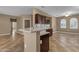 Open kitchen with stylish countertops, a breakfast bar, stainless steel dishwasher, and tiled flooring at 16525 W Tranquility Ln, Surprise, AZ 85387