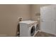 Laundry room with washer and dryer hookups near a door and some decorative fixtures at 16525 W Tranquility Ln, Surprise, AZ 85387