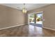 Spacious living room with tile flooring, light fixture, and sliding glass door to the backyard at 16525 W Tranquility Ln, Surprise, AZ 85387