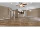 Spacious living room showcasing tile flooring, neutral wall color, open layout, and natural light with ceiling fan at 16525 W Tranquility Ln, Surprise, AZ 85387