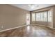 Empty main bedroom showcasing a large bay window, tile flooring, neutral wall color, and ceiling fan at 16525 W Tranquility Ln, Surprise, AZ 85387