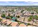Expansive aerial perspective of a community featuring single-Gathering homes, swimming pools, and green spaces in a neighborhood at 1672 W Butler Dr, Chandler, AZ 85224