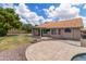 Spacious backyard featuring a fire pit area, a paved patio, and mature trees, creating an inviting outdoor space at 1672 W Butler Dr, Chandler, AZ 85224